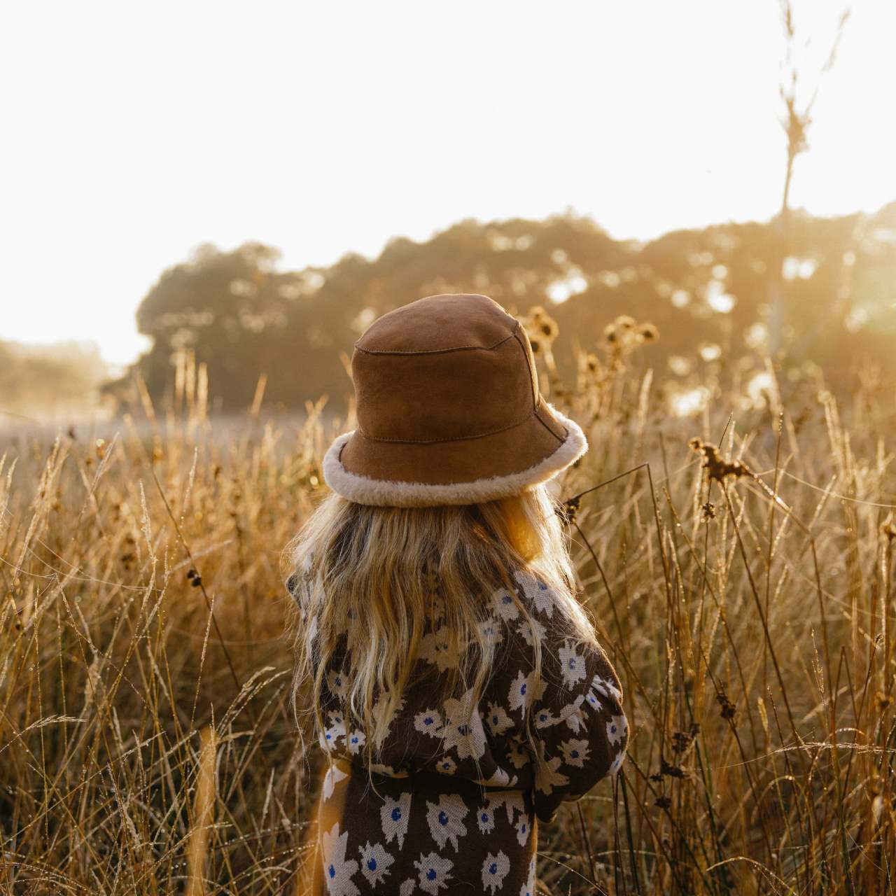Girl amongst the grass wearing a wool ugg bucket hat