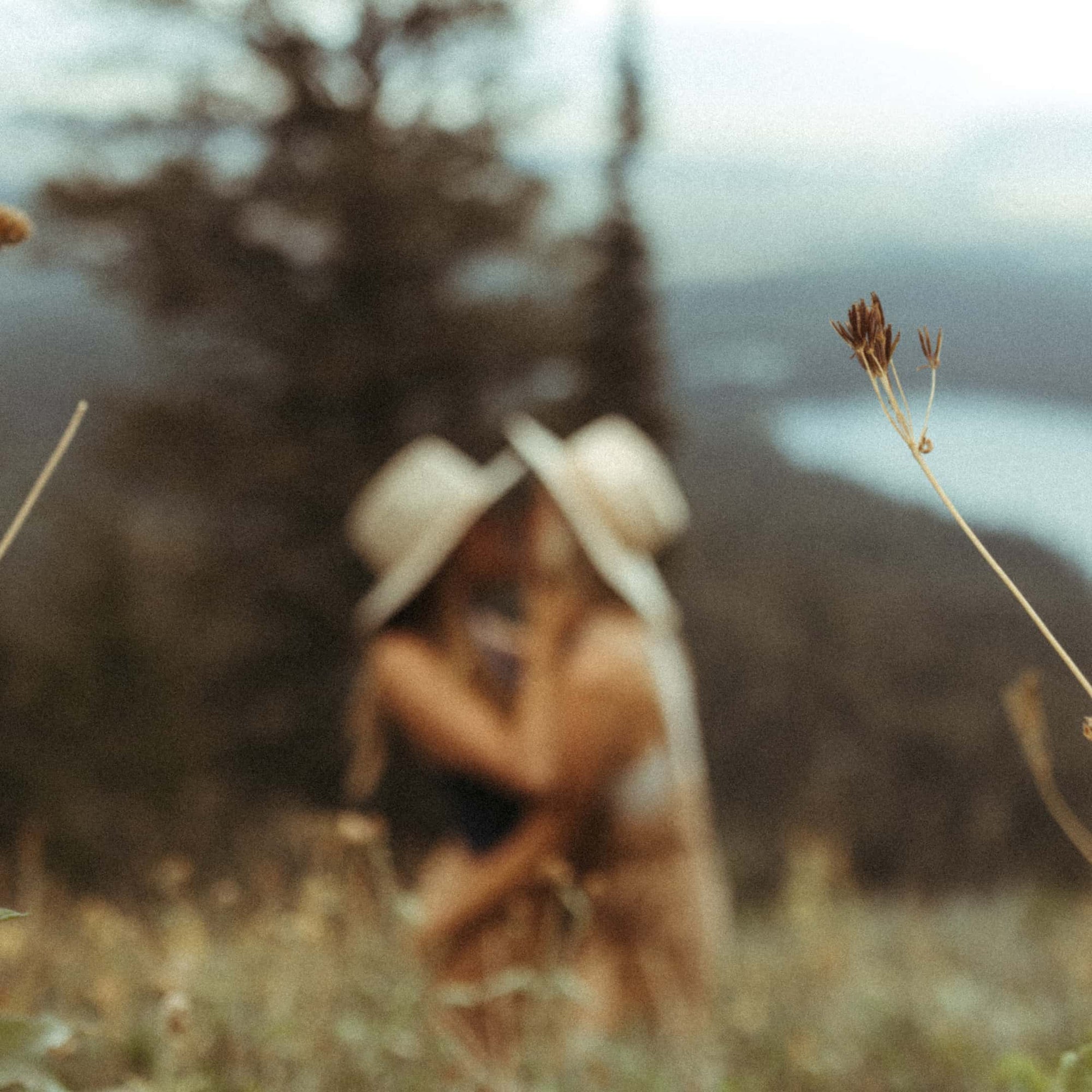 A blurry photo of Amanda and Taryn embracing in a grassy field