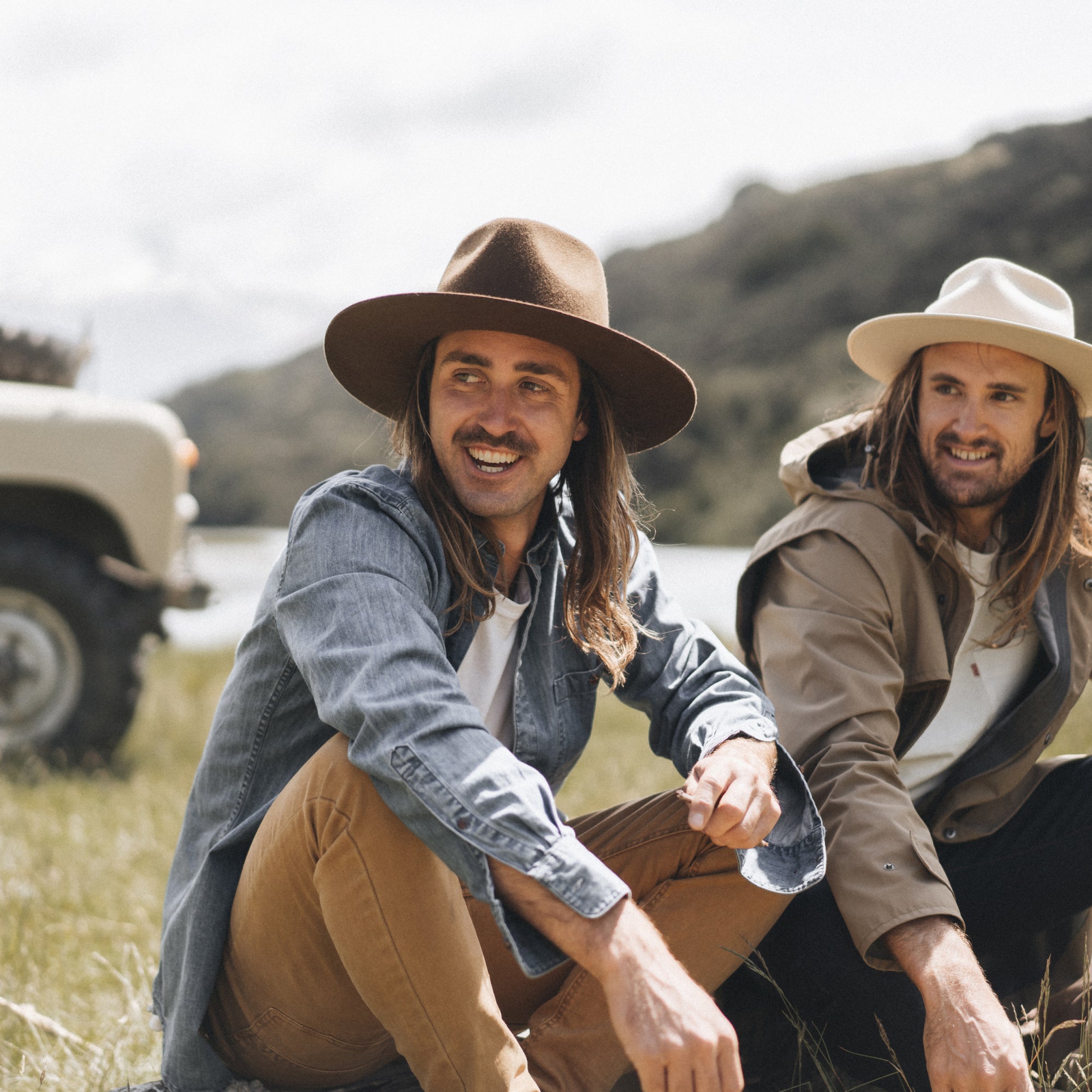 A close up photo of Stefan Haworth and Alex sitting together on the grass