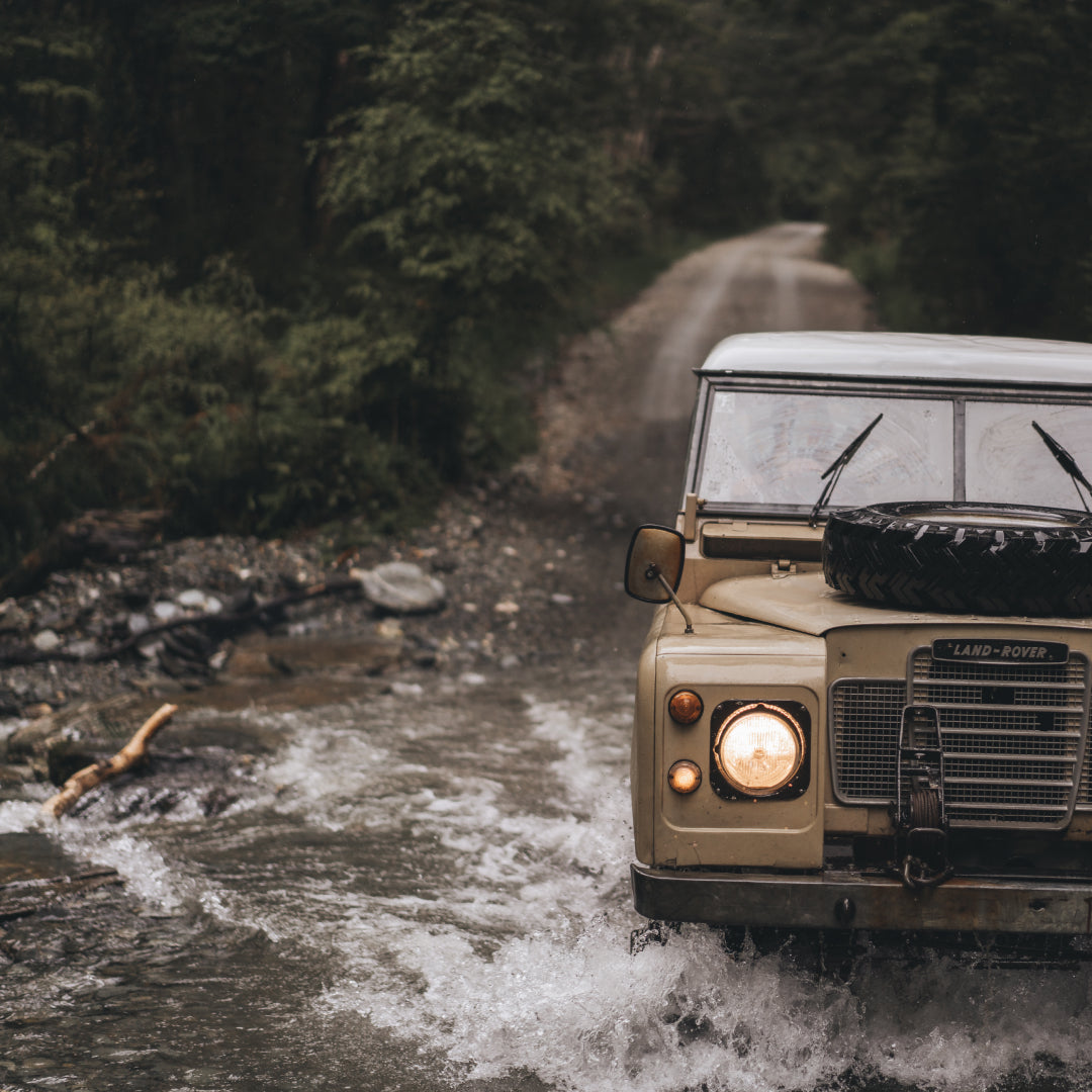 The Land Rover driving through a water crossing in New Zealand