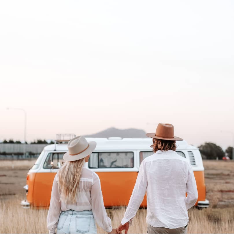 Tia and Jordy holding hands facing their van Stella