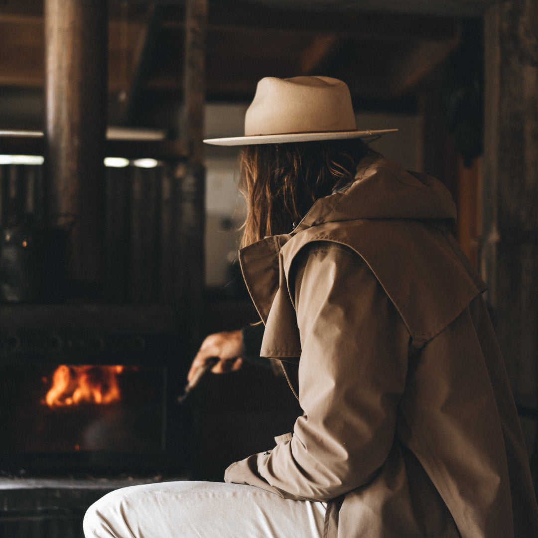 Alex inside a hunting cabin preparing the fire place