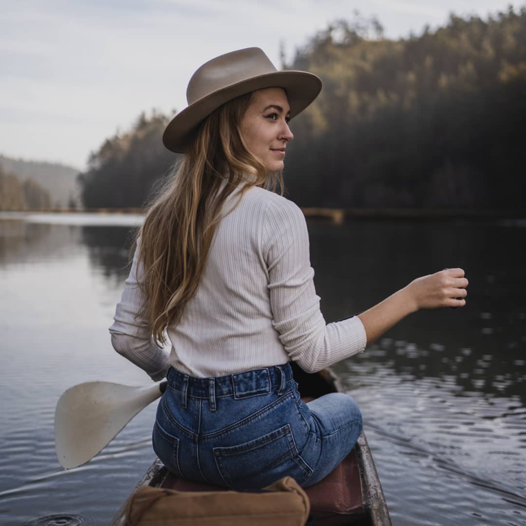 Melissa on the front of a canoe holding an oar