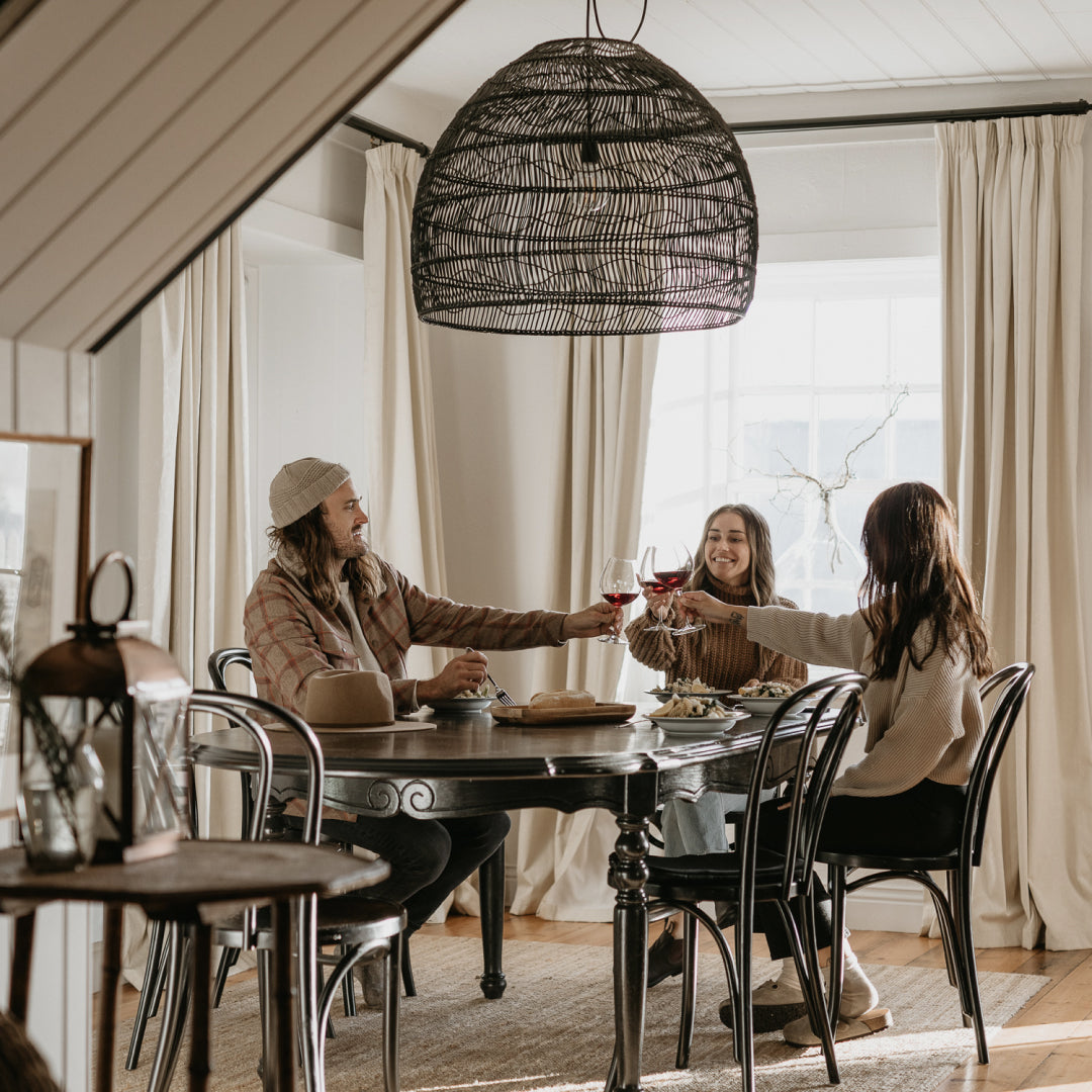 Three people having lunch together holding up their wine glasses