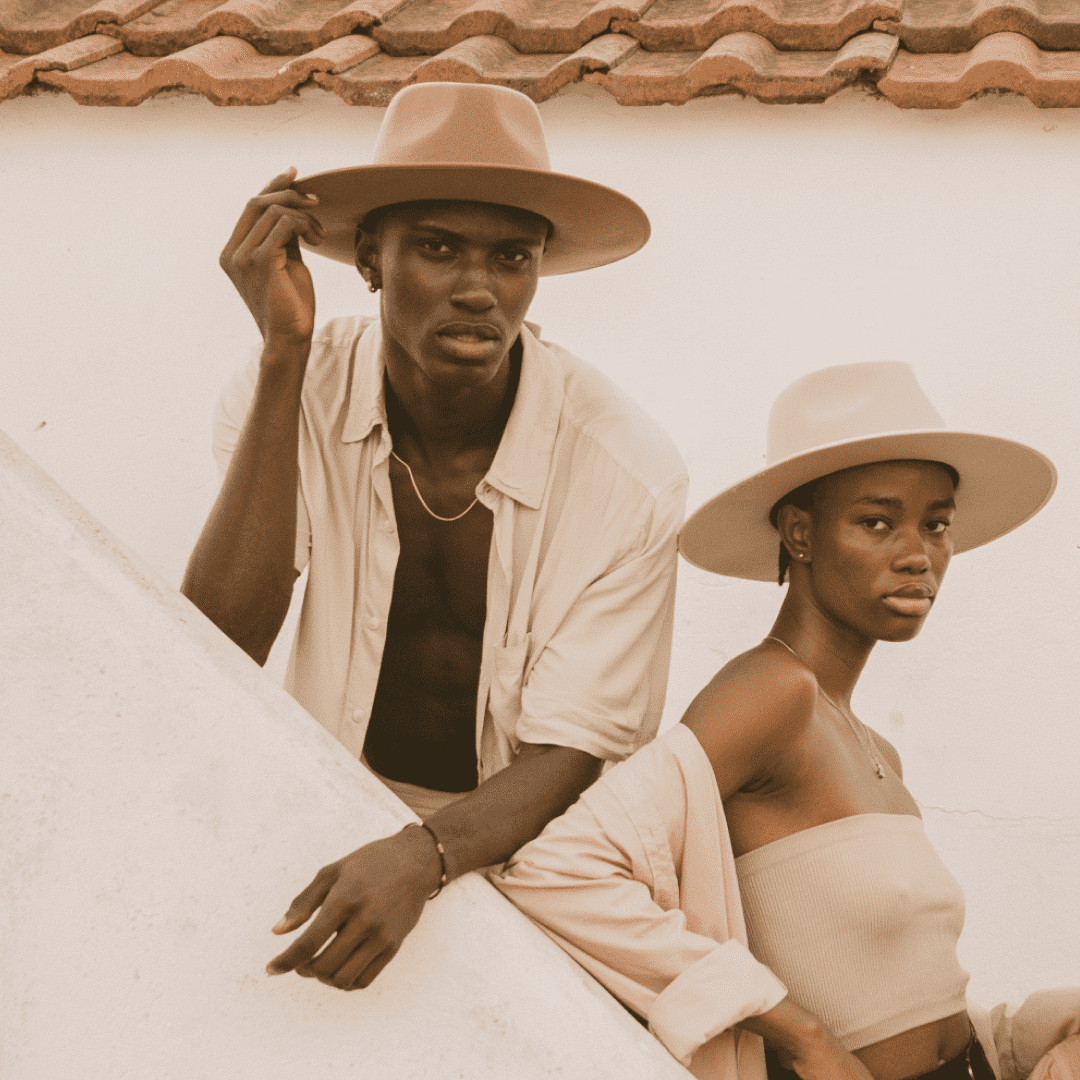 A man and a woman posing wearing wide brim wool hats
