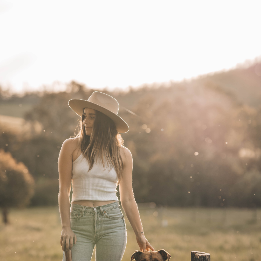 Lauren Williams standing in a field with a dog