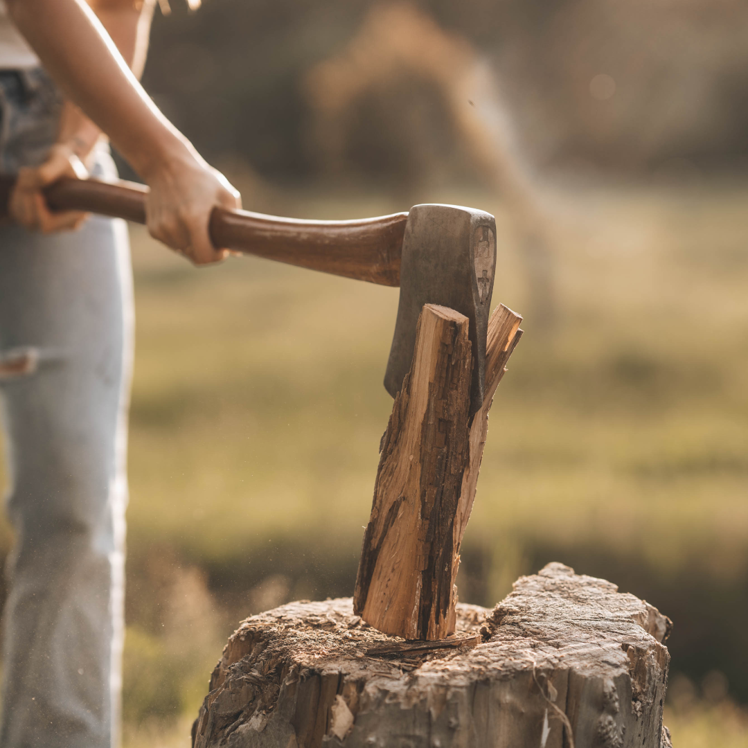 A close up of a piece of wood being chopped with an axe