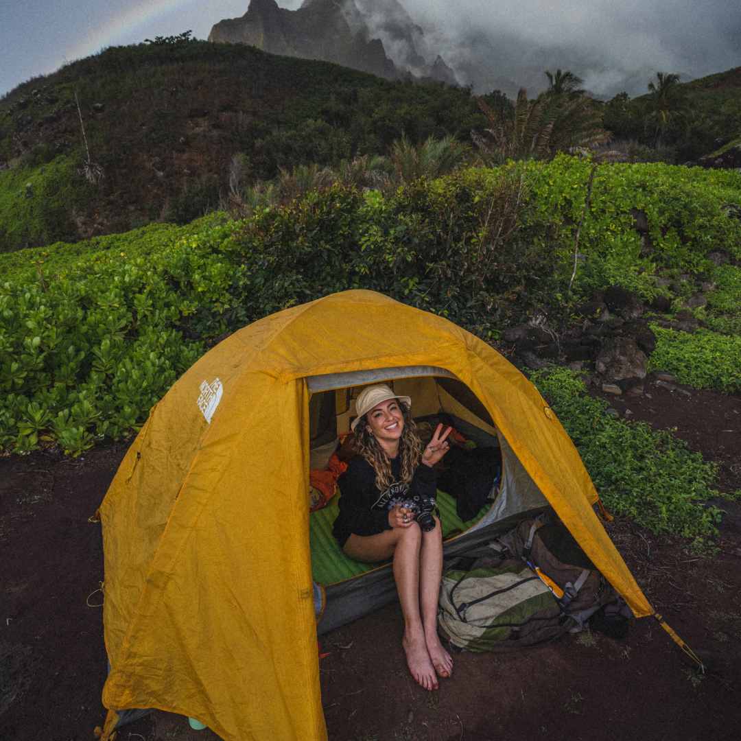 Chelsea Mealo sitting inside her tent in Hawaii