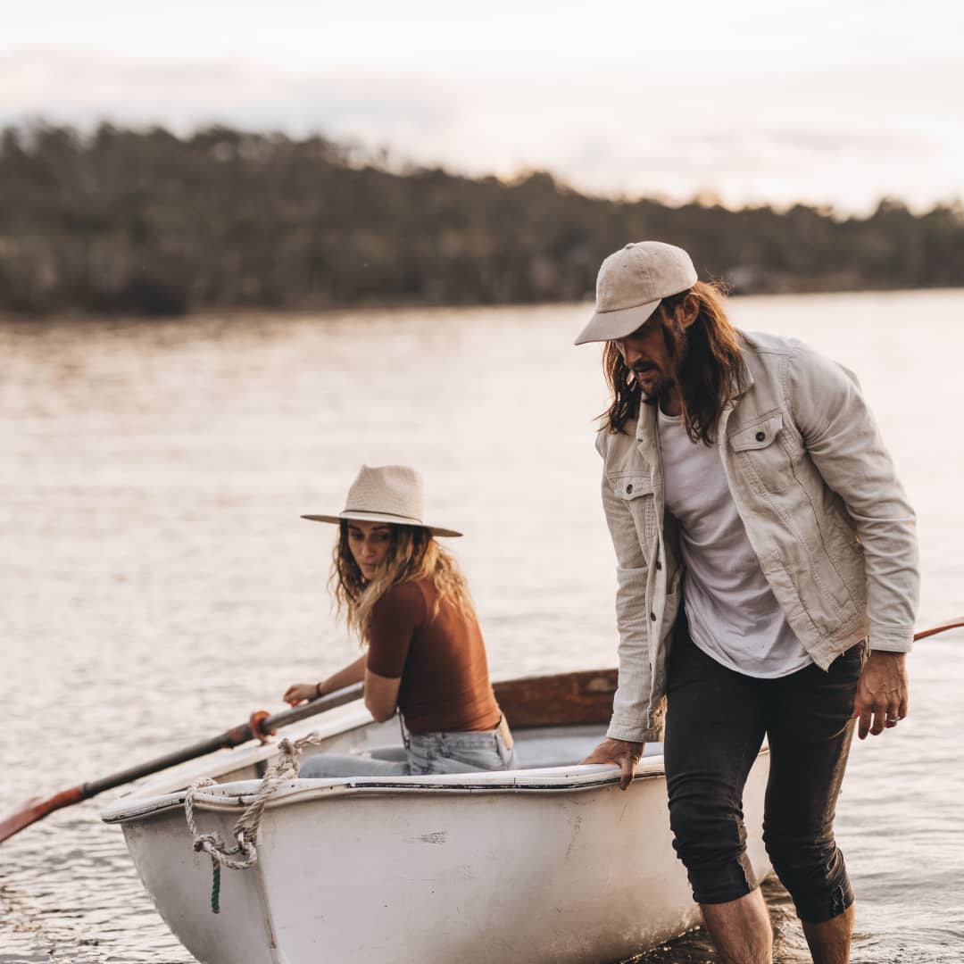 Alex pulling a small rowboat back to shore while Lauren is sitting inside