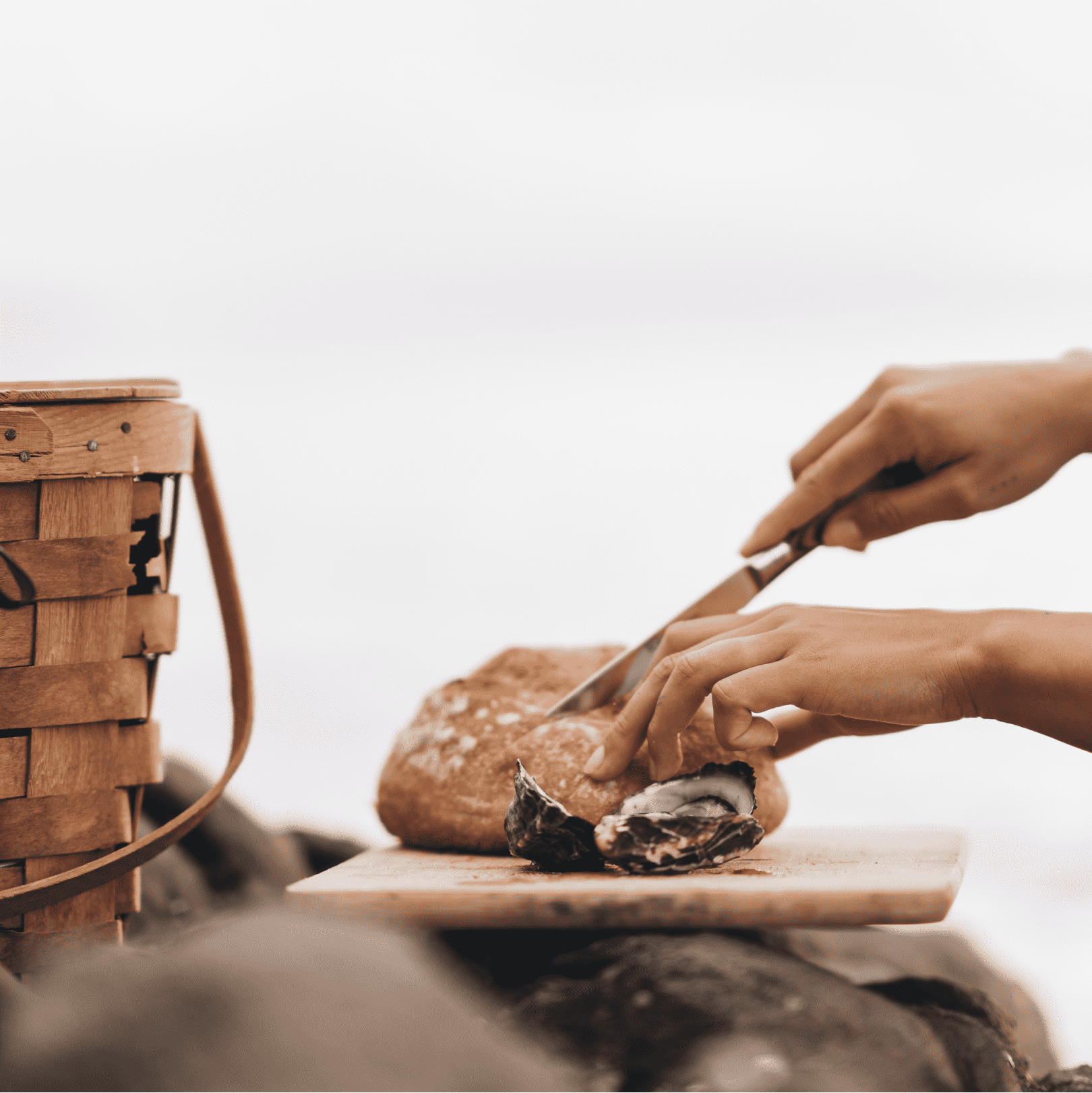 Close up photo of a person cutting sourdough bread