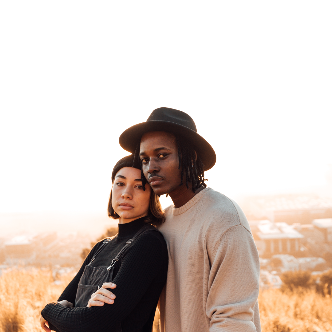 A woman and a man standing next to each other looking at the camera