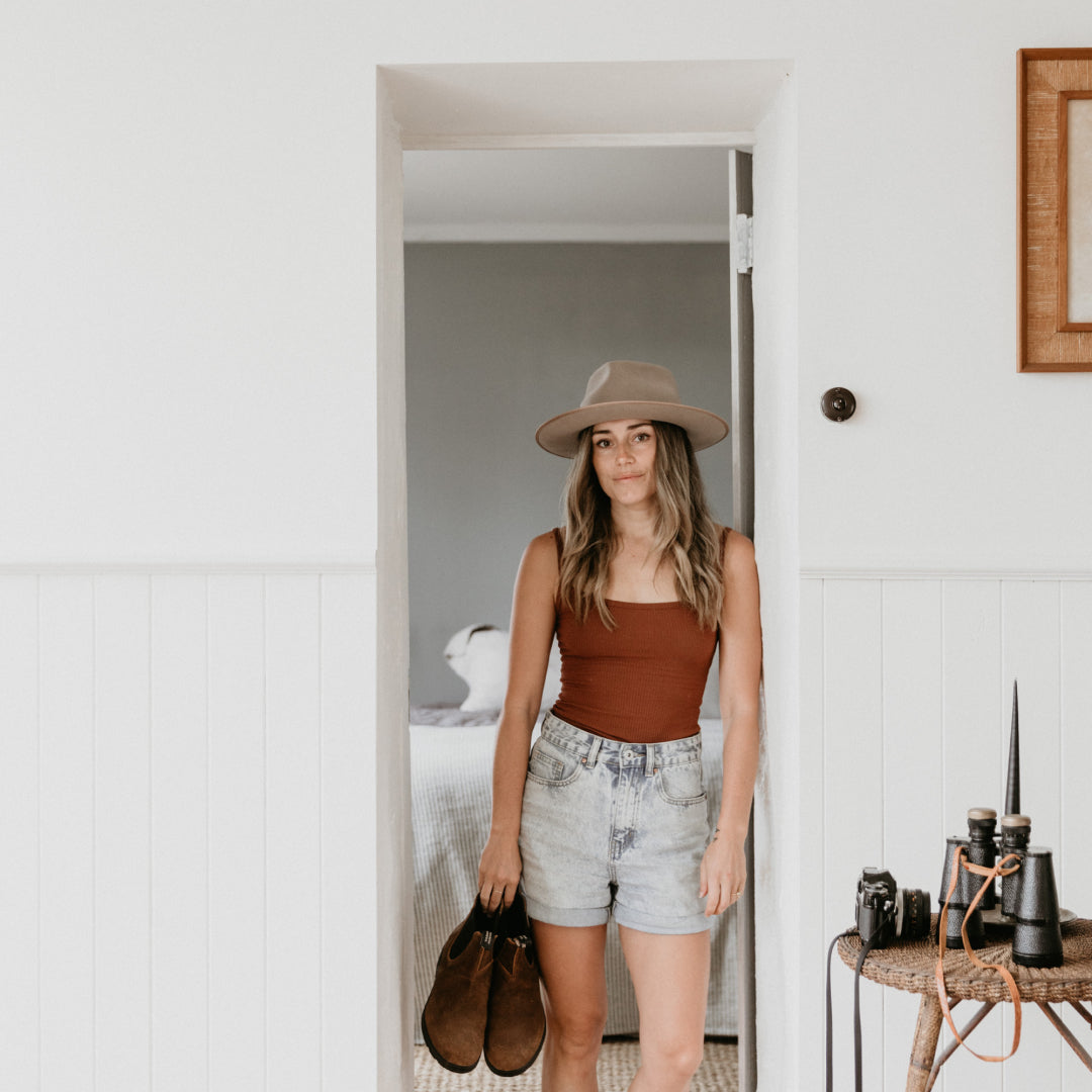 Lauren standing in the doorway inside a cottage