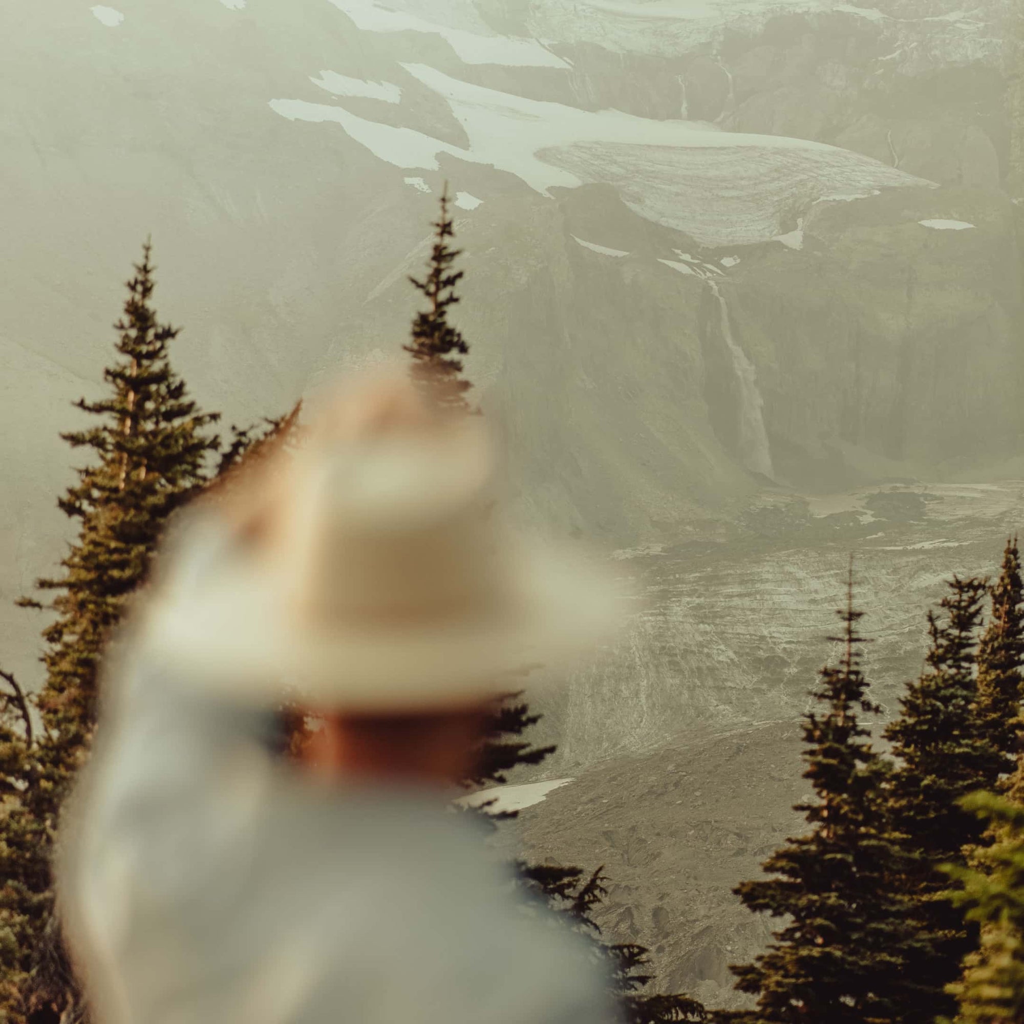 A man looks over at a scene of gorgeous mountain views
