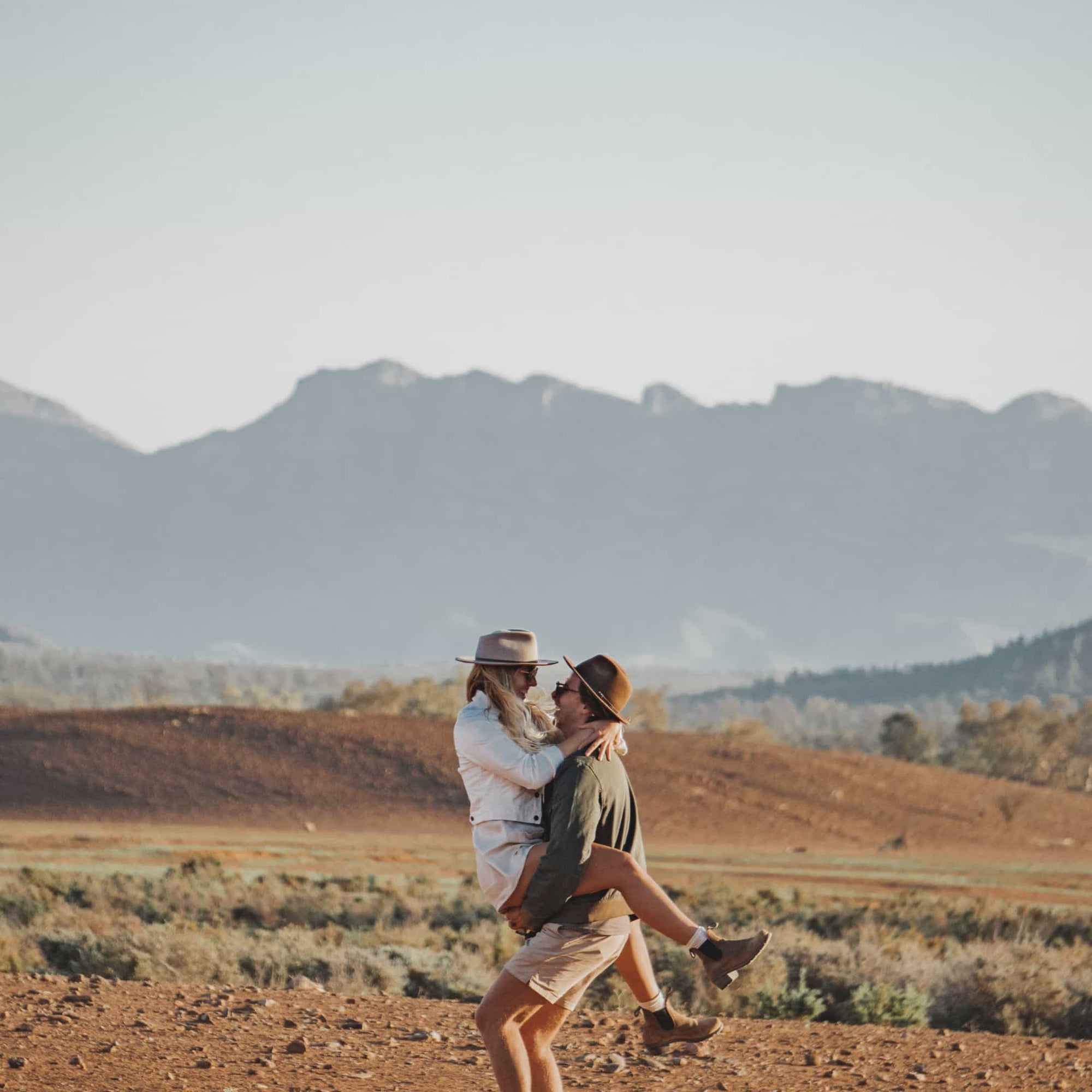 A young couple hugging in the middle of the desert in Australia