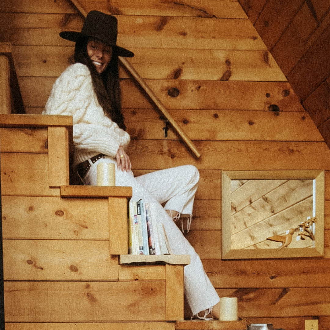 Stevie sitting on the stairs of the Flagstaff cabin