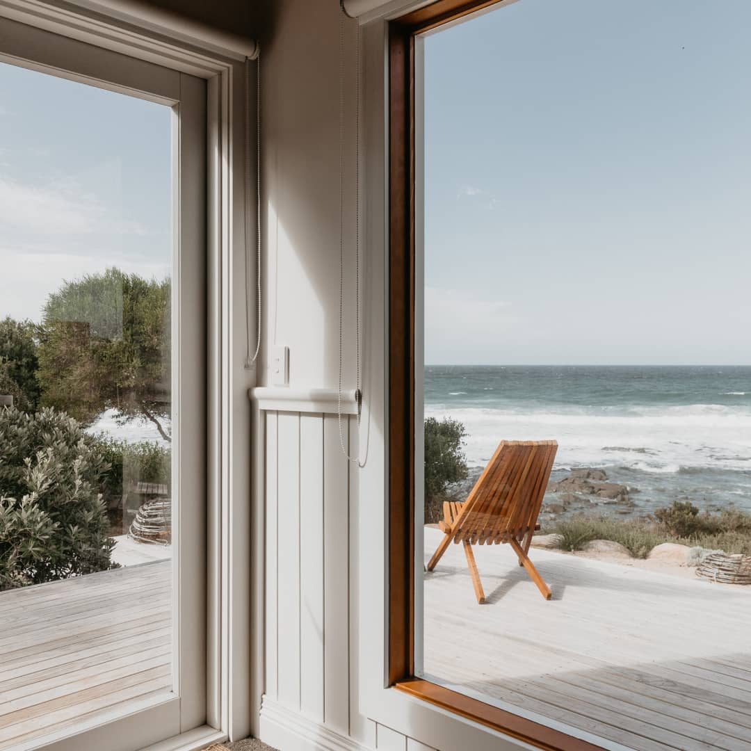 View of the ocean through the windows of a beach shack