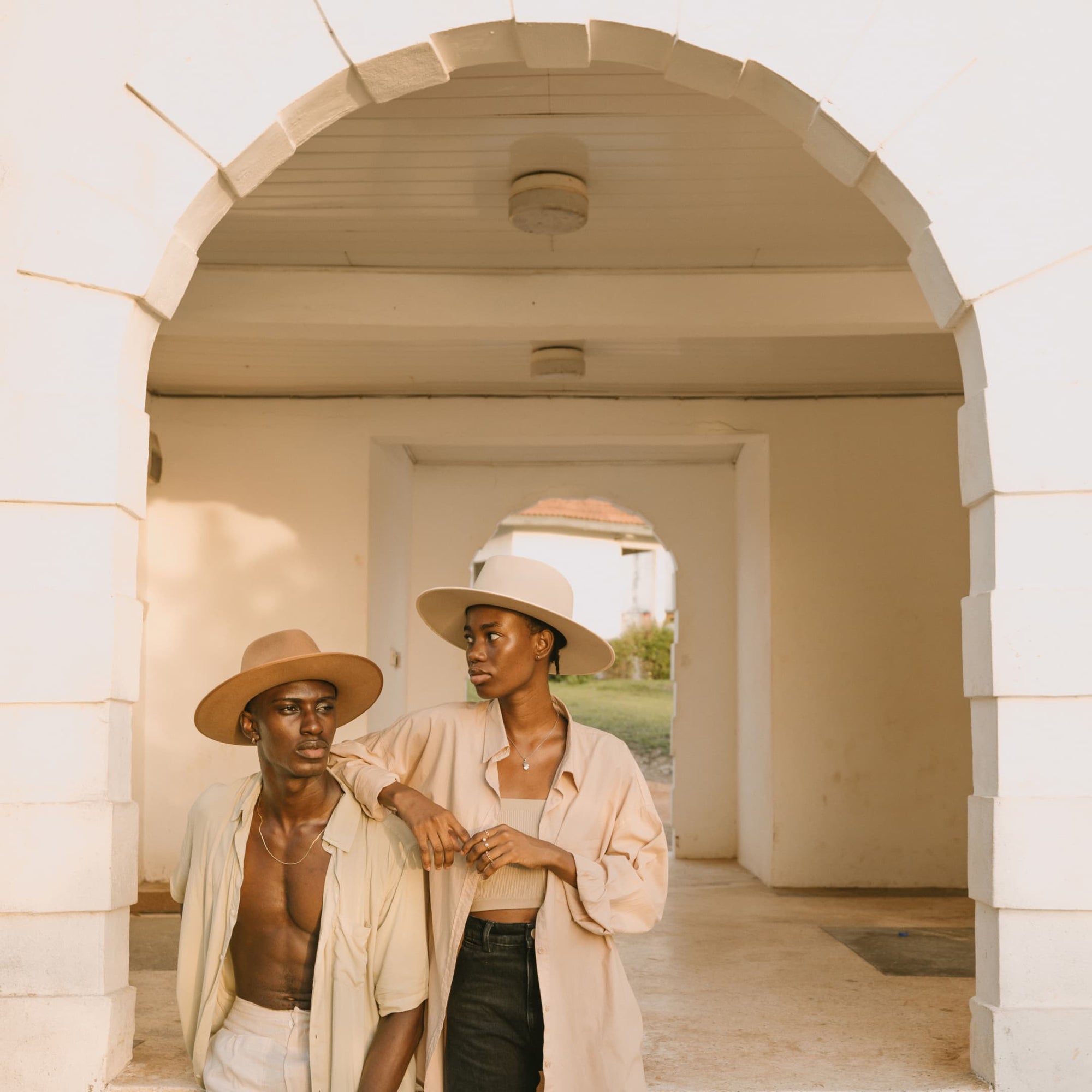 A man and a woman sitting on the side of a building step in Ghana