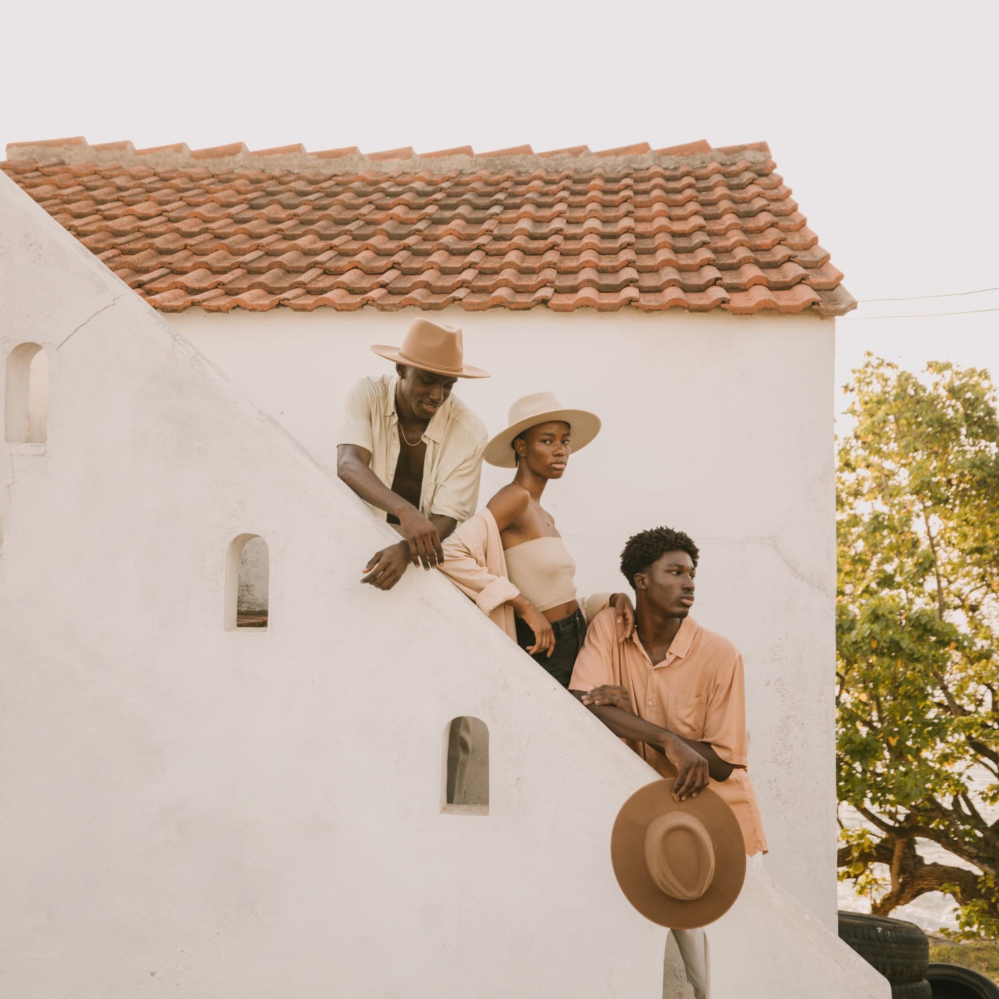Three people standing on the steps of a building in Ghana, Africa